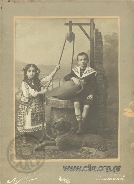 Boy and girl at a water well