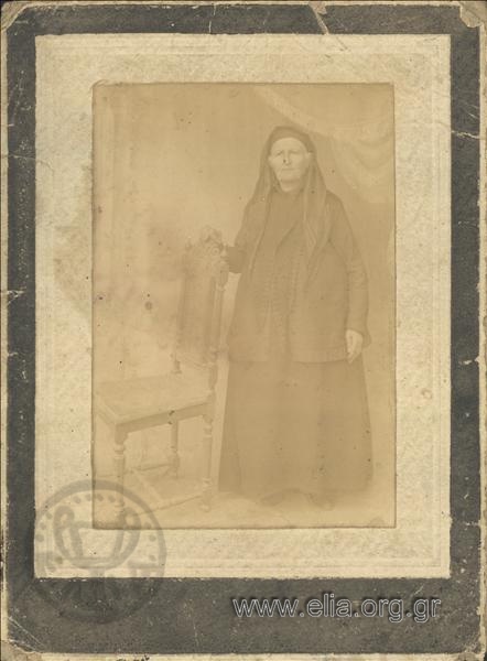 Portrait of an elderly woman in a traditional dress.