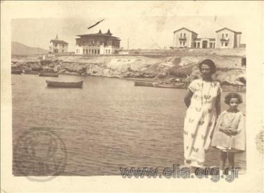 Portrait of a woman and a girl by the sea.