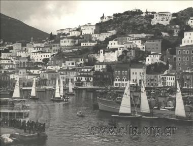 Sailboaters. View of houses and the port.