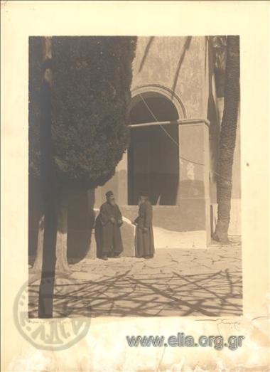 Two monks in the yard of a monastery
