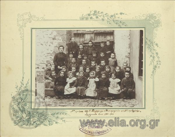 Group portrait of first-class students with a Nursery School teacher.