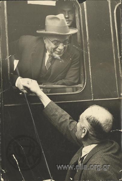 Ioannis Metaxas talking with a man out of the window of a railway carriage