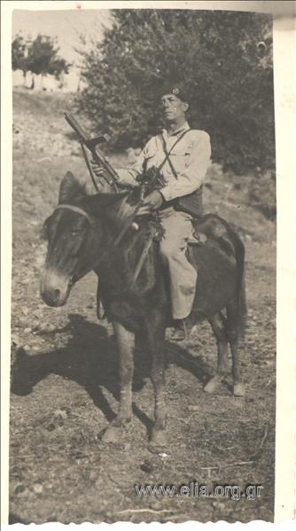 Serviceman riding a donkey.