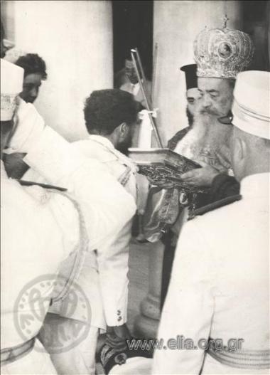 Emperor of Ethiopia Haile Selassie kissing the Bible on entering the Cathedral