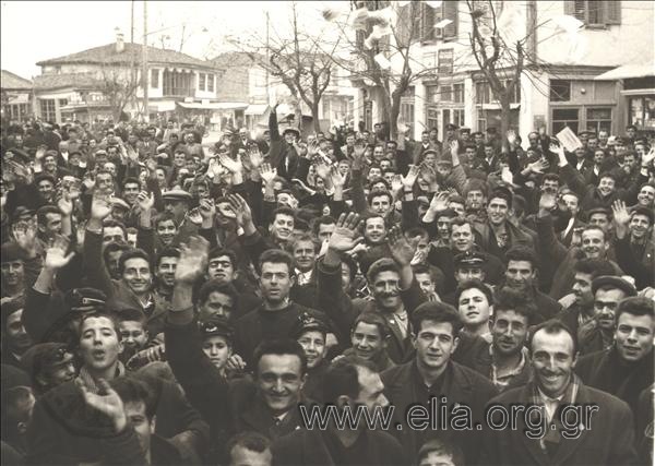 Assembled crowd cheering, possibly during the visit of a politician to a provincial town.