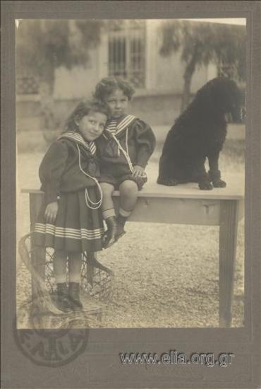 Vasiliki and Nikolaos Voudouris with the dog of the house