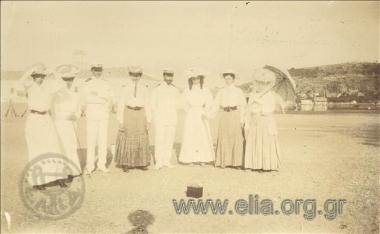 Company of officers and women on a beach