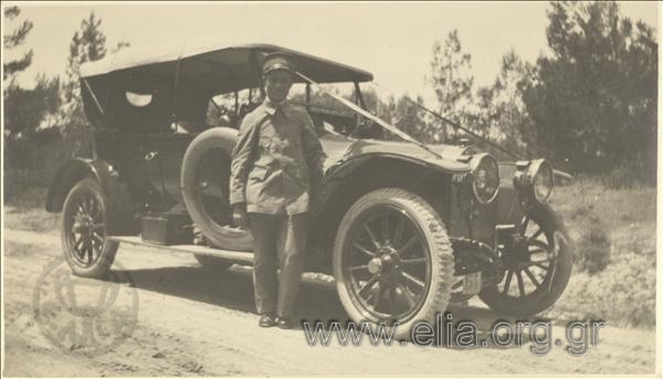 Serviceman posing next to his car.