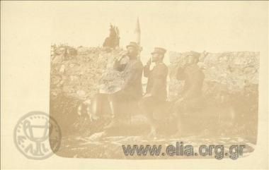 Kimon Digenis and two military officer s on a cannon