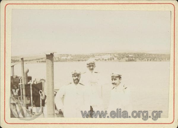Nikolaos Votsis, Stefanos Paparigopoulos and a  Royal Navy officer on the deck of a torpedo boat