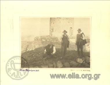 Sofoklis Dousmanis and two other men in front of a mill.