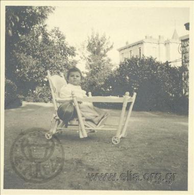 Nikolas Kalas (1907-1988) as a baby on a chair in his garden in Kifisia.