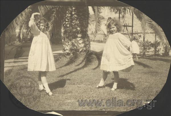 Princesses Olga and Elissavet perform a dancing figure in the garden.