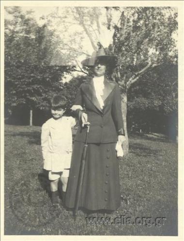 Nikolas Kalas (1907-1988) as a child with his nanny in a park.