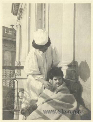 Nikolas Kalas (1907-1988) as a child, wrapped in a blanket, with a nurse