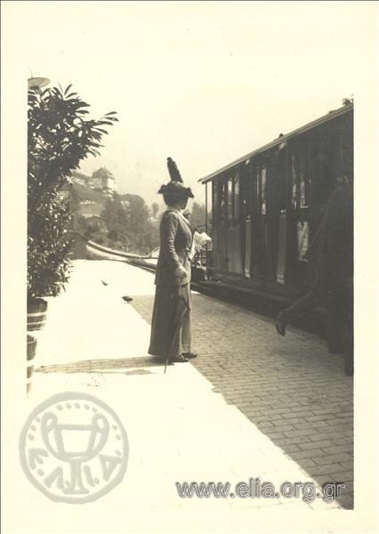 Woman by a tram, Champ Palace.