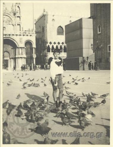 Nikolas Kalas (1907-1988) as a child feeding pigeons at Ag. Markou Square.