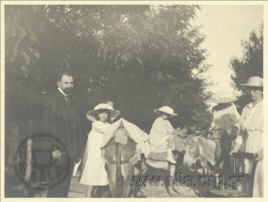 The father of Nikolas Kalas (1907-1988), Ioannis, with children of the royal family with donkeys on a road.