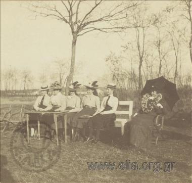 Five young women with tennis racquets in a park