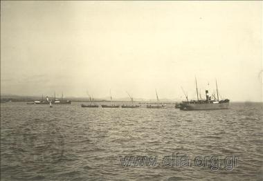 Barges approaching a transport ship for unloading, harbour of Dedeagats.
