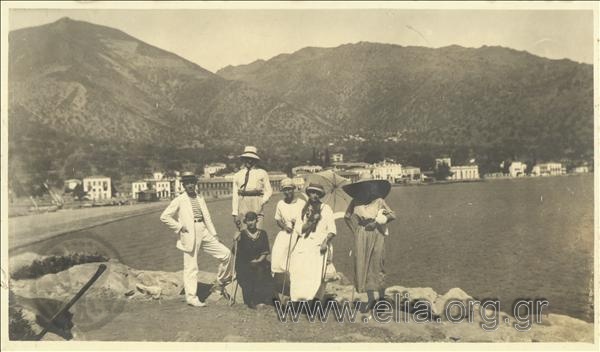 Excursionists  with the settlement in the background