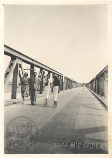 A group of friends crossing a bridge.