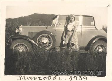 Woman and a dog by a car