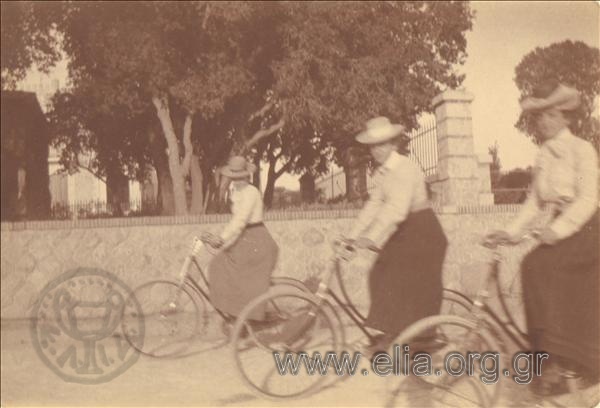 Three women on bikes.