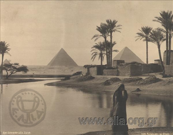 The Pyramids of Giza, a woman next to a lake.