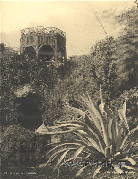 The garden of Ezbekîye, a coffee house in the background.