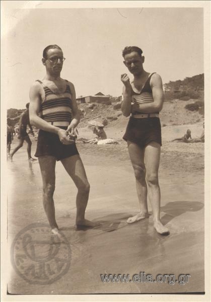 Portrait of two men in swimsuits on the coast.