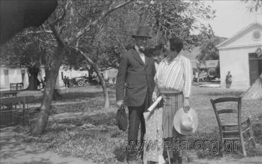 Iris with an unknown man. Cars in the background
