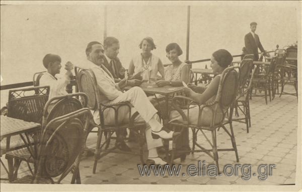 Gerasimos V. Vasiliadis and his company playing cards on a veranda (of a hotel?)