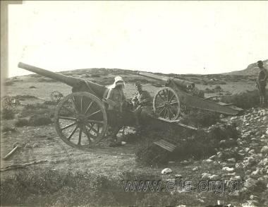 Artillerymen leaning against a cannon.