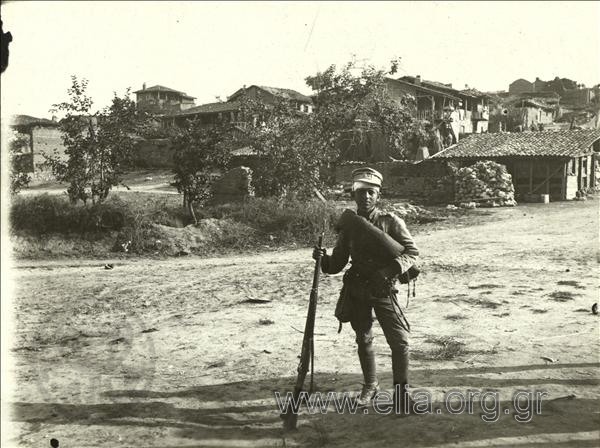 Young (Greek ?) soldier in a village during the Balkan War II.