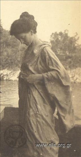 Eva Palmer with a dog next to the sea.