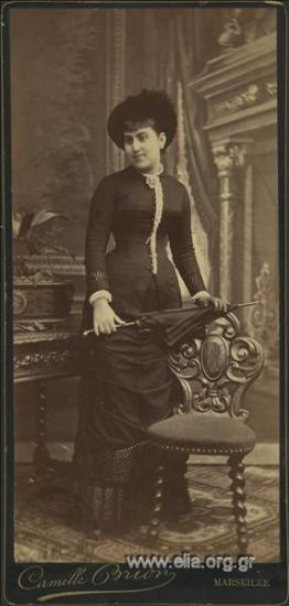 Portrait of a young woman with a hat and umbrella.