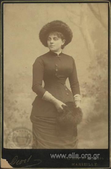 Portrait of a young woman with a fur hat and muff