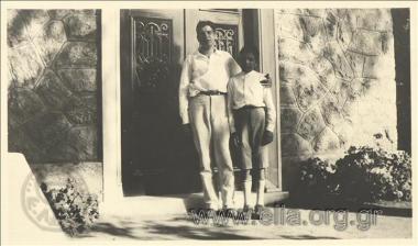 Stefanos G. Streit and boy at the entrance of a house.