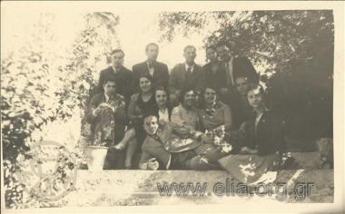 Stefanos G. Streit in a company of men and women in a garden.