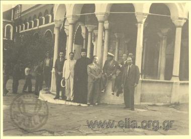 Stefanos G. Streit with a company of men in the courtyard of a monastery.