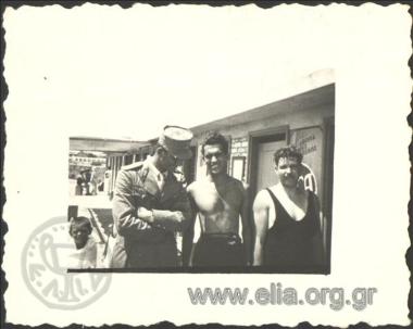 Stefanos G. Streit in swimsuit and two men in the baths.