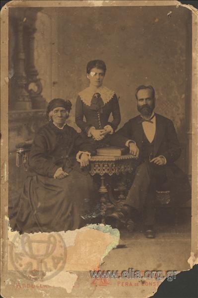 Portrait of two women and man.