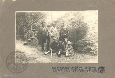 Portrait of a family in a garden, next to a staircase