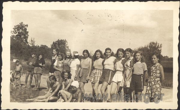 Group portrait of the girls of the Greek  Camp of Olympians near the sea.