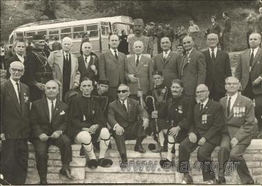 Group portrait in front of a monument to Paul  Melas, in a memorial of the fallen in the Macedonian Wars.