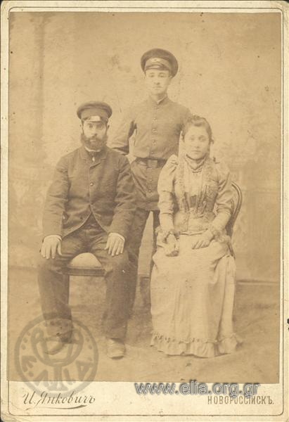 Portrait of two men and a woman.