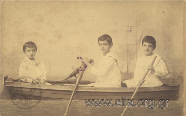 Three boys in a model of boat.