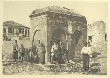 Frech soldier and village people at a fountain in Nigrita